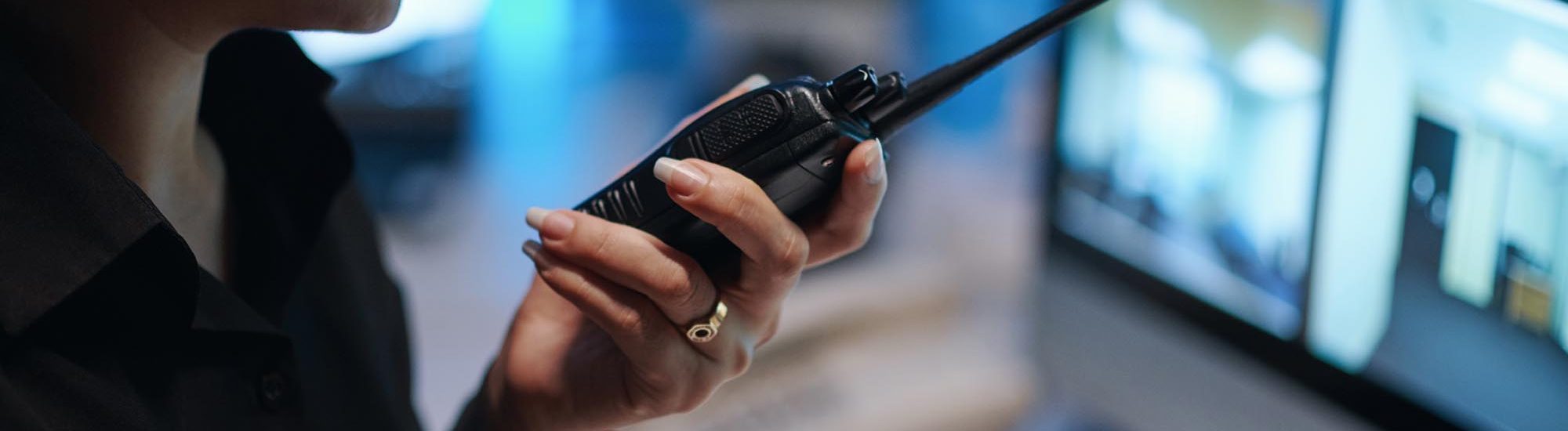 Security Worker Talking By Radio With Colleague